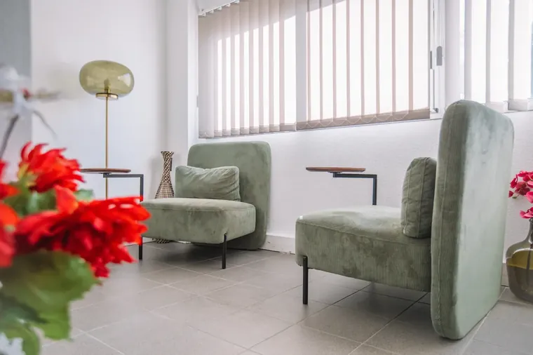 Lounge with green velvet armchairs at the Millénaire coworking centre — the welcoming corner where the day actually happens